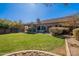 Spacious backyard with lush green grass and a patio area at 17353 N 99Th St, Scottsdale, AZ 85255