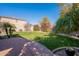 Landscaped backyard featuring a grassy lawn and brick pavers at 17353 N 99Th St, Scottsdale, AZ 85255