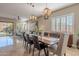 Bright dining room featuring a wood table, neutral decor, and large windows at 17353 N 99Th St, Scottsdale, AZ 85255