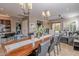 Elegant dining room with a long wooden table and modern light fixtures at 17353 N 99Th St, Scottsdale, AZ 85255