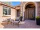 inviting front entry with brick pavers and comfortable seating at 17353 N 99Th St, Scottsdale, AZ 85255