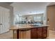 Kitchen island with sink, dishwasher, and view into Gathering room at 17353 N 99Th St, Scottsdale, AZ 85255