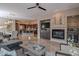 Open living area with a fireplace, built-in entertainment center, and large windows at 17353 N 99Th St, Scottsdale, AZ 85255