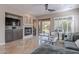 Living room featuring a fireplace, built-in cabinetry, and backyard access at 17353 N 99Th St, Scottsdale, AZ 85255