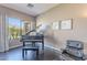 Music room with a grand piano, comfortable chair and natural light at 17353 N 99Th St, Scottsdale, AZ 85255