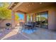 Covered patio with dining area, string lights, and built-in grill at 17353 N 99Th St, Scottsdale, AZ 85255