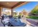 Outdoor patio with seating area and lush green backyard at 17353 N 99Th St, Scottsdale, AZ 85255