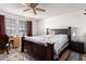 Spacious bedroom with dark wood furniture and ceiling fan at 17463 N 63Rd Dr, Glendale, AZ 85308