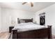 Large bedroom with dark wood bed frame and walk-in closet at 17463 N 63Rd Dr, Glendale, AZ 85308