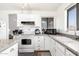 Bright kitchen with white cabinets, granite countertops, and modern appliances at 17463 N 63Rd Dr, Glendale, AZ 85308