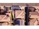 A top-down aerial view of a residential neighborhood with tiled roofs and solar panels, depicting urban planning and design at 17749 W Woodrow Ln, Surprise, AZ 85388