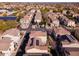 An aerial view of a neighborhood showcasing neatly arranged homes with desert landscaping and select solar panel installations at 17749 W Woodrow Ln, Surprise, AZ 85388