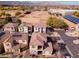 Aerial view of a suburban neighborhood featuring modern homes with solar panels and community amenities at 17749 W Woodrow Ln, Surprise, AZ 85388