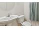 Compact half bathroom includes a pedestal sink and modern toilet at 17749 W Woodrow Ln, Surprise, AZ 85388