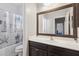 Bathroom featuring a vanity with a framed mirror, sink, and a shower-tub combo at 17749 W Woodrow Ln, Surprise, AZ 85388