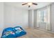 Cozy bedroom with a ceiling fan and a window offering natural light at 17749 W Woodrow Ln, Surprise, AZ 85388