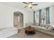 Inviting living room with a ceiling fan, archway, plush sofa, and a stylish round coffee table at 17749 W Woodrow Ln, Surprise, AZ 85388