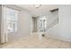 Open concept living room features tile flooring, a staircase, and ample natural light at 17749 W Woodrow Ln, Surprise, AZ 85388