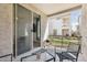 Relaxing patio with a grill, chairs, and a glass table, perfect for outdoor entertaining at 17749 W Woodrow Ln, Surprise, AZ 85388