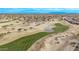 Aerial view of a golf course community with houses, landscaping, and a pond at 17802 N Bridle Ln, Surprise, AZ 85374