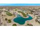 Aerial view of a golf course with a large pond at 17802 N Bridle Ln, Surprise, AZ 85374