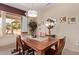 Bright dining room with wooden table and backyard view at 17802 N Bridle Ln, Surprise, AZ 85374