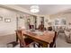 Casual dining area with wooden table and view into living room at 17802 N Bridle Ln, Surprise, AZ 85374