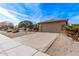 Two-car garage with tan colored doors and stucco exterior at 17802 N Bridle Ln, Surprise, AZ 85374