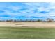 Golf course putting green with distant homes at 17802 N Bridle Ln, Surprise, AZ 85374