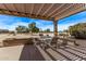 Relaxing patio with pergola, table and chairs, overlooking a golf course at 17802 N Bridle Ln, Surprise, AZ 85374