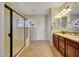 Bathroom with a double vanity, granite countertop, and large shower at 17842 W Chuckwalla Canyon Rd, Goodyear, AZ 85338