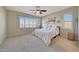 Spacious bedroom with a ceiling fan and large windows at 17842 W Chuckwalla Canyon Rd, Goodyear, AZ 85338