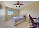 Well-lit bedroom with a comfortable bed and workspace setup at 17842 W Chuckwalla Canyon Rd, Goodyear, AZ 85338