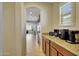 Kitchen breakfast bar with coffee bar and view to living room at 17842 W Chuckwalla Canyon Rd, Goodyear, AZ 85338