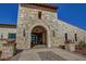 Elegant community center entrance with stone exterior and arched entryway at 17842 W Chuckwalla Canyon Rd, Goodyear, AZ 85338