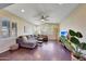 Spacious living room with L-shaped sectional sofa and hardwood floors at 17842 W Chuckwalla Canyon Rd, Goodyear, AZ 85338