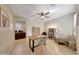 Home office with wood desk, ceiling fan and comfortable seating at 17842 W Chuckwalla Canyon Rd, Goodyear, AZ 85338