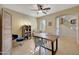 Bright home office features wood desk, ceiling fan, and built-in shelving at 17842 W Chuckwalla Canyon Rd, Goodyear, AZ 85338