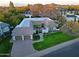 Aerial view of a home featuring a two-car garage and courtyard surrounded by lush greenery at 18 W Kaler Dr, Phoenix, AZ 85021