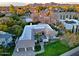 High aerial view of the house surrounded by mature landscaping, beautiful pool, and patio at 18 W Kaler Dr, Phoenix, AZ 85021