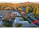 Aerial view of house with a large lot surrounded by mature landscaping with mountain views at 18 W Kaler Dr, Phoenix, AZ 85021