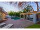 Beautiful backyard featuring a pool, outdoor lounge area, mature trees, and landscape lighting at 18 W Kaler Dr, Phoenix, AZ 85021