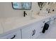 Bright double vanity with marble countertops, black fixtures and hardware at 18 W Kaler Dr, Phoenix, AZ 85021