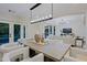 Open concept dining area with modern chandelier, comfortable seating, and a view to the outdoor pool at 18 W Kaler Dr, Phoenix, AZ 85021