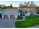 Aerial view of home featuring a lush green lawn, brick driveway, and two car garage at 18 W Kaler Dr, Phoenix, AZ 85021