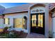 Elegant entryway with beautiful landscaping and a glimpse into the modern kitchen at 18 W Kaler Dr, Phoenix, AZ 85021