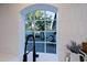 Bright kitchen view of the backyard through an arched window above the sink at 18 W Kaler Dr, Phoenix, AZ 85021