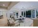 Cozy living room with fireplace, chandelier and an open floor plan at 18 W Kaler Dr, Phoenix, AZ 85021