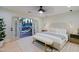 Bright main bedroom featuring a ceiling fan, light hardwood floors, and French doors to an outdoor patio at 18 W Kaler Dr, Phoenix, AZ 85021