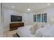 Cozy main bedroom with plush bedding, wood floors, plantation shutters, and modern decor at 18 W Kaler Dr, Phoenix, AZ 85021